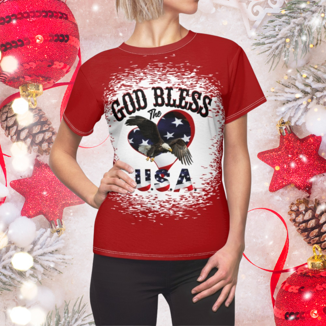 Red t-shirt with 'God Bless the USA' design worn by a person, surrounded by Christmas decorations.