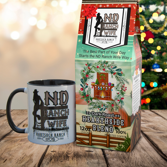 ND Ranch Wife coffee mug and packaging on a wooden surface with a Christmas tree in the background.