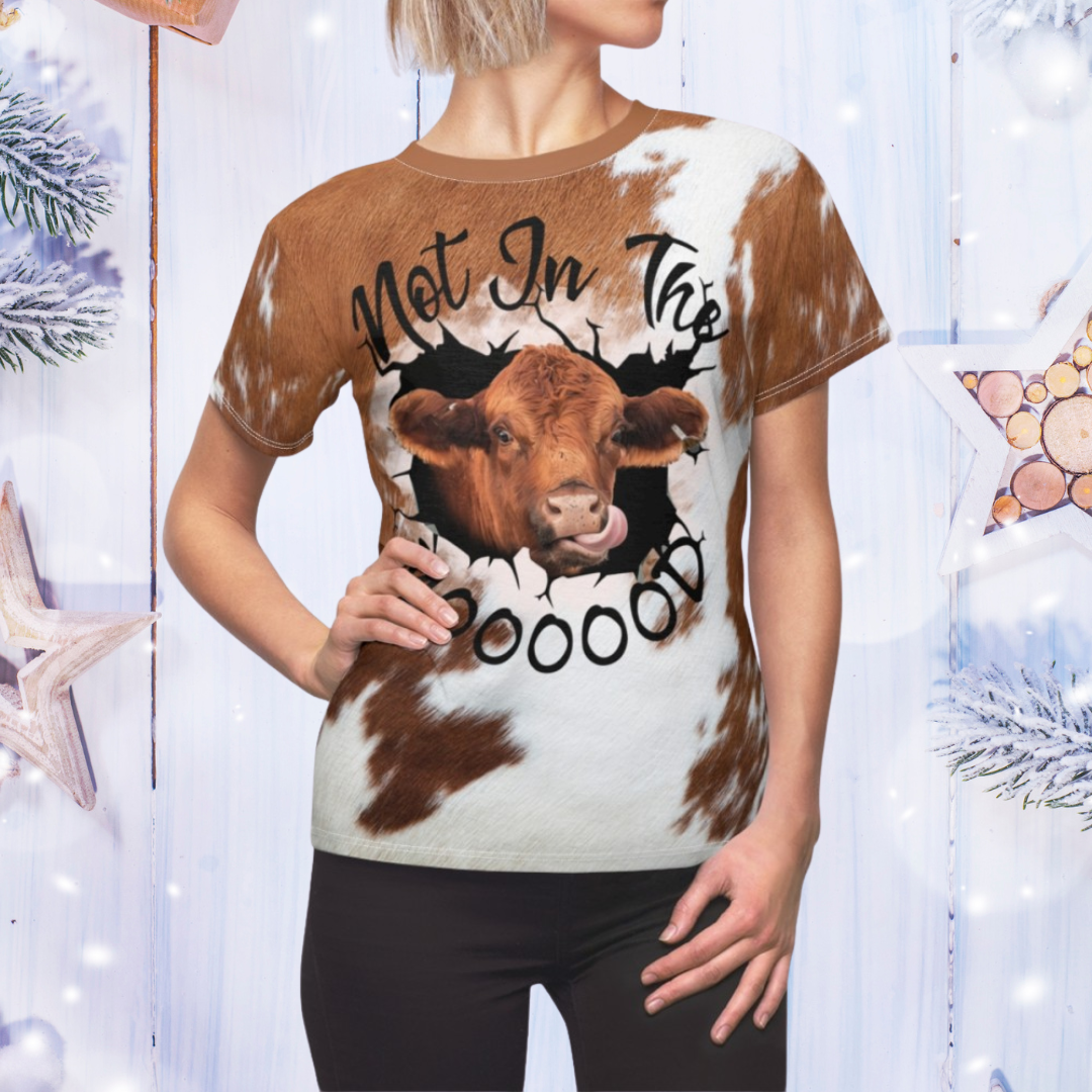 Person wearing a t-shirt with a cow graphic and text in a decorative setting