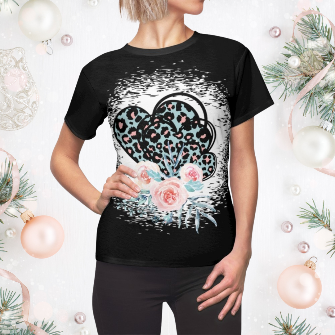 Black t-shirt with a heart design featuring leopard print, flowers, and headphones on a decorative background.